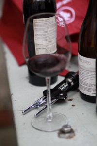 Glass of wine with bottles and opener